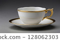 Elegant white porcelain tea cup and saucer with gold decorations standing on gray background 128062303