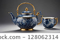 Elegant blue and white porcelain teapot and teacup with gold decorations and floral pattern 128062314