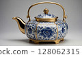 Elegant blue and white porcelain teapot with golden details standing on gray background 128062315