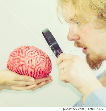 Man investigating human brain using magnifer Man investigating human brain using magnifer 128062477