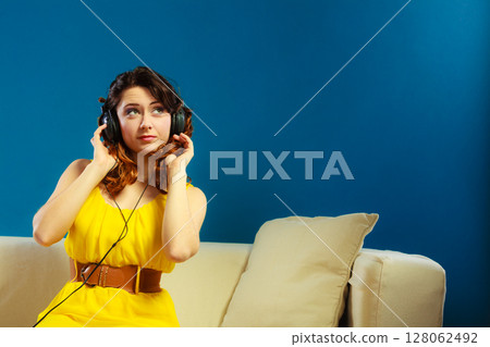 girl in big headphones listening music mp3 relaxing 128062492