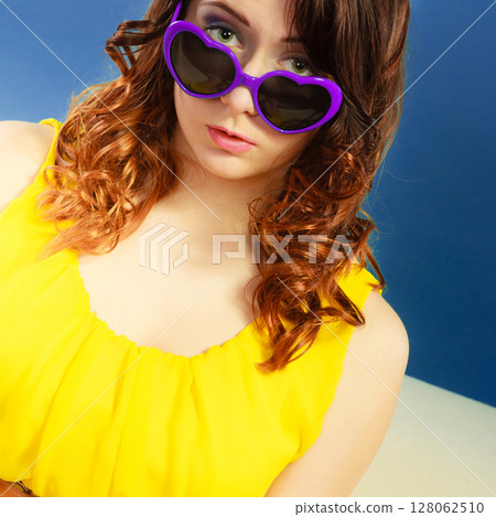 Girl in violet sunglasses portrait 128062510