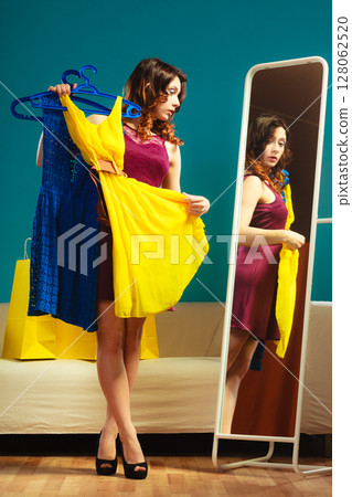 Woman trying dress shopping for clothing. 128062520