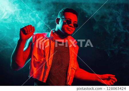 Stylish Man Dressed In Net Dancing In Neon Light, Smoke Studio Or In Night Club 128063424