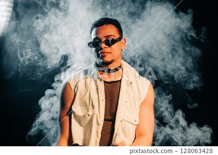 Freaky Clubber Man In Sunglasses Smiling, Stylish Guy Portrait In Neon Light Freaky Clubber Man In Sunglasses Smiling, Stylish Guy Portrait In Neon Light 128063428