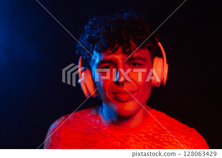 Hipster Man Dressed In Net Dancing In Neon Light In Night Club.music, Headphones Hipster Man Dressed In Net Dancing In Neon Light In Night Club.music, Headphones 128063429