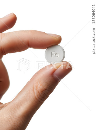 Iron supplement tablet held in hand, health and anemia treatment concept mineral pill dietary nutrition Iron supplement tablet held in hand, health and anemia treatment concept mineral pill dietary nutrition 128064041