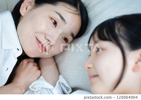 Mom sleeping with her daughter 128064904