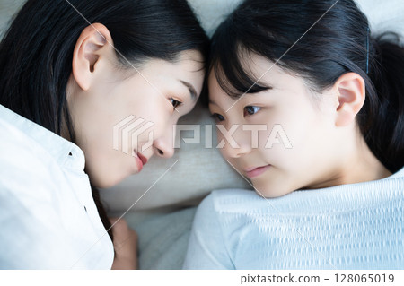 Daughter and mom sleeping together Daughter and mom sleeping together 128065019
