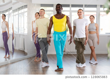 Group of motivated people mastering movements of folk Celtic dance 128065863