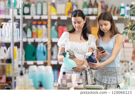 Woman with daughter scanning qr code for spray 128066123