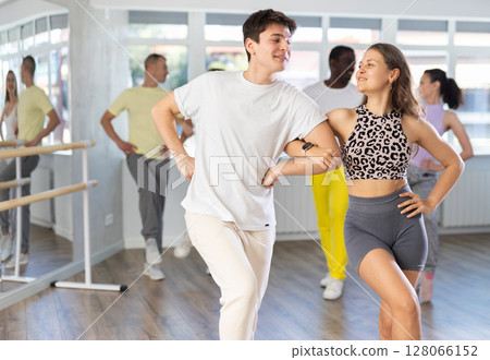 Group of middle aged dancers rehearsing ballroom dances in dance studio Group of middle aged dancers rehearsing ballroom dances in dance studio 128066152