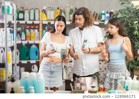 Family choosing toothbrush in store during summer 128066171