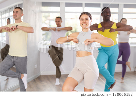 European girl with team of like-minded multinational people learn to elements of electro dance 128066192