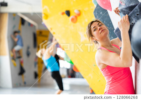 Woman exercising in climbing gym 128066268