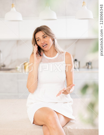 conversing on phone with discernible tone conversing on phone with discernible tone 128066348