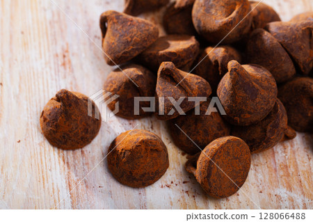 Chocolate truffles on wooden background Chocolate truffles on wooden background 128066488