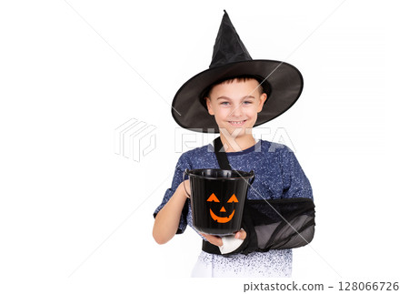 Portrait emotional boy black witch hat, bucket pumpkin Jack sweet candies. Isolated white background 128066726