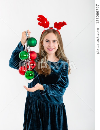 Merry Christmas cute girl reindeer antlers holding Christmas decorations isolated white background 128066797