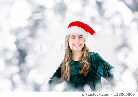 Merry Christmas Cheerful cute girl Santa hat holding Christmas decorations isolated white background Merry Christmas Cheerful cute girl Santa hat holding Christmas decorations isolated white background 128066809
