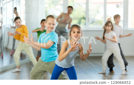 Positive juvenile boy and girl engaged in Rock 'n' Roll dance during dancing classes 128066852