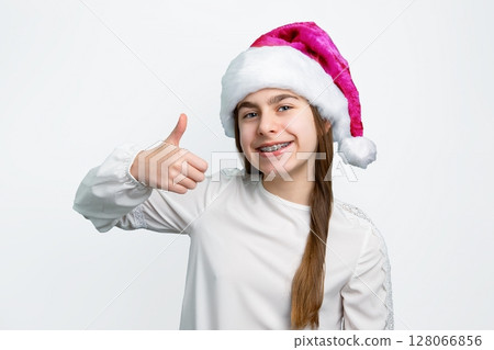 Girl Santa hat showing joy, delight, surprise, approval. Happy emotions, joy Christmas concept. 128066856