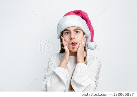 Girl Santa hat showing joy, delight, surprise, approval. Happy emotions, joy Christmas concept. 128066857