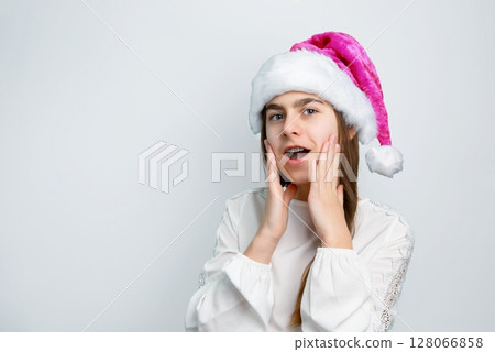 Girl Santa hat showing joy, delight, surprise, approval. Happy emotions, joy Christmas concept. 128066858