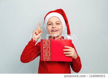 Boy Santa hat holding envelope, postcard, greeting, letter Santa different funny emotions, surprise Boy Santa hat holding envelope, postcard, greeting, letter Santa different funny emotions, surprise 128066931
