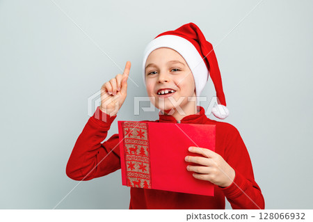 Boy Santa hat holding envelope, postcard, greeting, letter Santa different funny emotions, surprise Boy Santa hat holding envelope, postcard, greeting, letter Santa different funny emotions, surprise 128066932