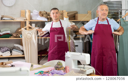 Male tailors doing a warm-up at work Male tailors doing a warm-up at work 128067036