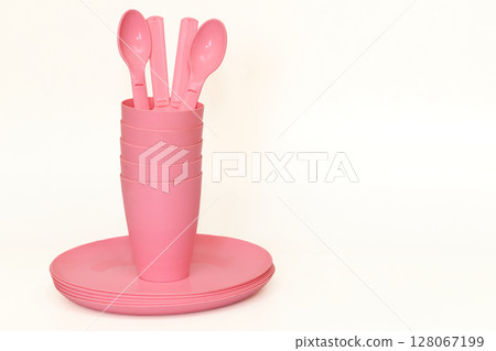 Pink plastic plates,fork,cups,spoon for camping, isolated on white Pink plastic plates,fork,cups,spoon for camping, isolated on white 128067199