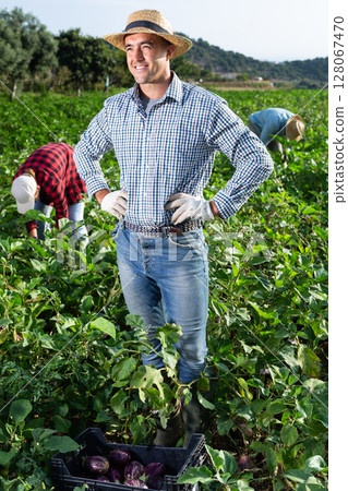 Portrait of satisfied farmer in front of his farm on sunny summer day Portrait of satisfied farmer in front of his farm on sunny summer day 128067470