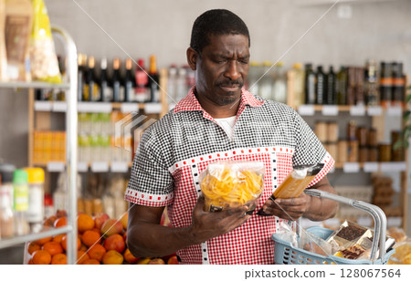 Adult man choosing pasta in store Adult man choosing pasta in store 128067564