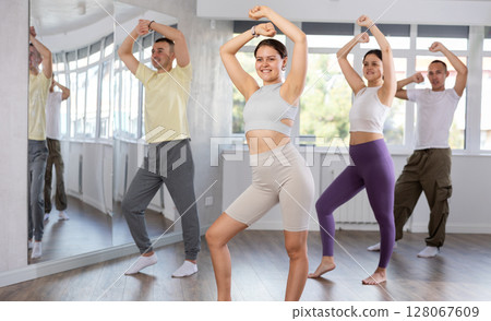 European girl with team of like-minded multinational people learn to elements of electro dance European girl with team of like-minded multinational people learn to elements of electro dance 128067609