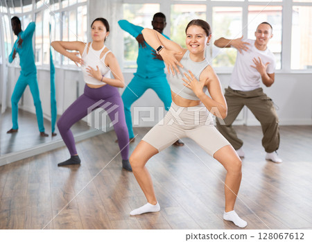 European girl with team of like-minded multinational people learn to elements of electro dance European girl with team of like-minded multinational people learn to elements of electro dance 128067612