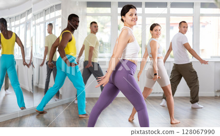 Group of people dancing modern dances Group of people dancing modern dances 128067990