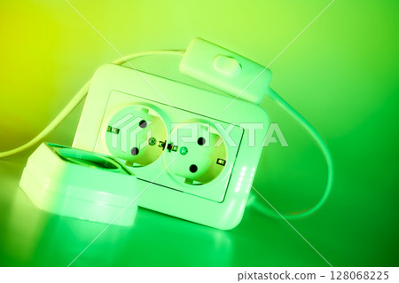 Two electrical sockets,connecting devices,switch in green light 128068225