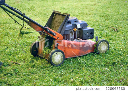 Professional grass cutting on lawns with handle lawn mower 128068580