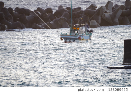 Fishing boat illuminated by the morning sun Fishing boat illuminated by the morning sun 128069455