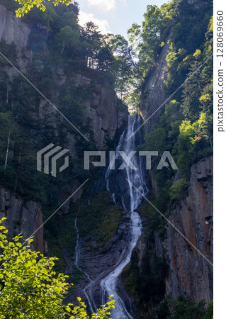 Waterfall running down the mountainside 128069660