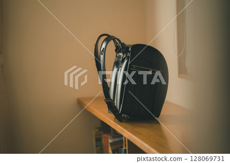 black school bag placed in the living room 128069731
