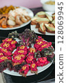 Various tasty food on the table, snacks, drinks and vegetables at the open-air buffet 128069945