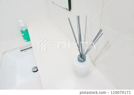 Reed diffusers placed at the washbasin of a public restroom 128070171