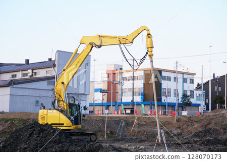 Earth auger during ground improvement work at a construction site 128070173