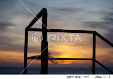 Morning sun and the silhouette of the embankment railing 128070891