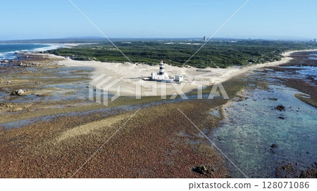 Solitary Beacon Guarding Wind-Swept Coastal Sands Solitary Beacon Guarding Wind-Swept Coastal Sands 128071086