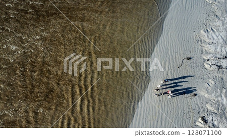 Gathered Shadows Amidst Rippling Coastal Shoreline Patterns Gathered Shadows Amidst Rippling Coastal Shoreline Patterns 128071100