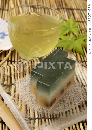 Mizuyokan and cold green tea on a black background Mizuyokan and cold green tea on a black background 128071689
