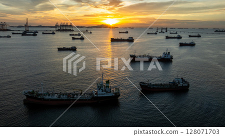 Aerial view oil tanker ship and gas tanker ship at sunset, Silhouette oil and gas tanker ship at oil and gas terminal, Global business import export logistic transportation oil and gas. 128071703